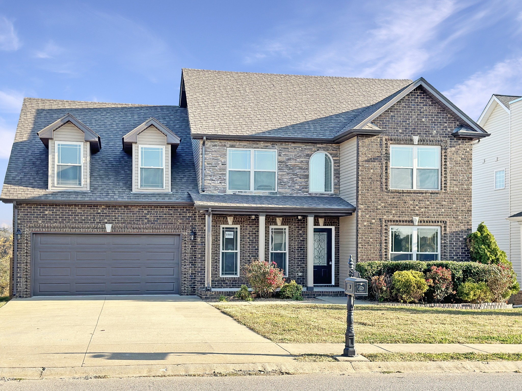 a front view of a house with garden