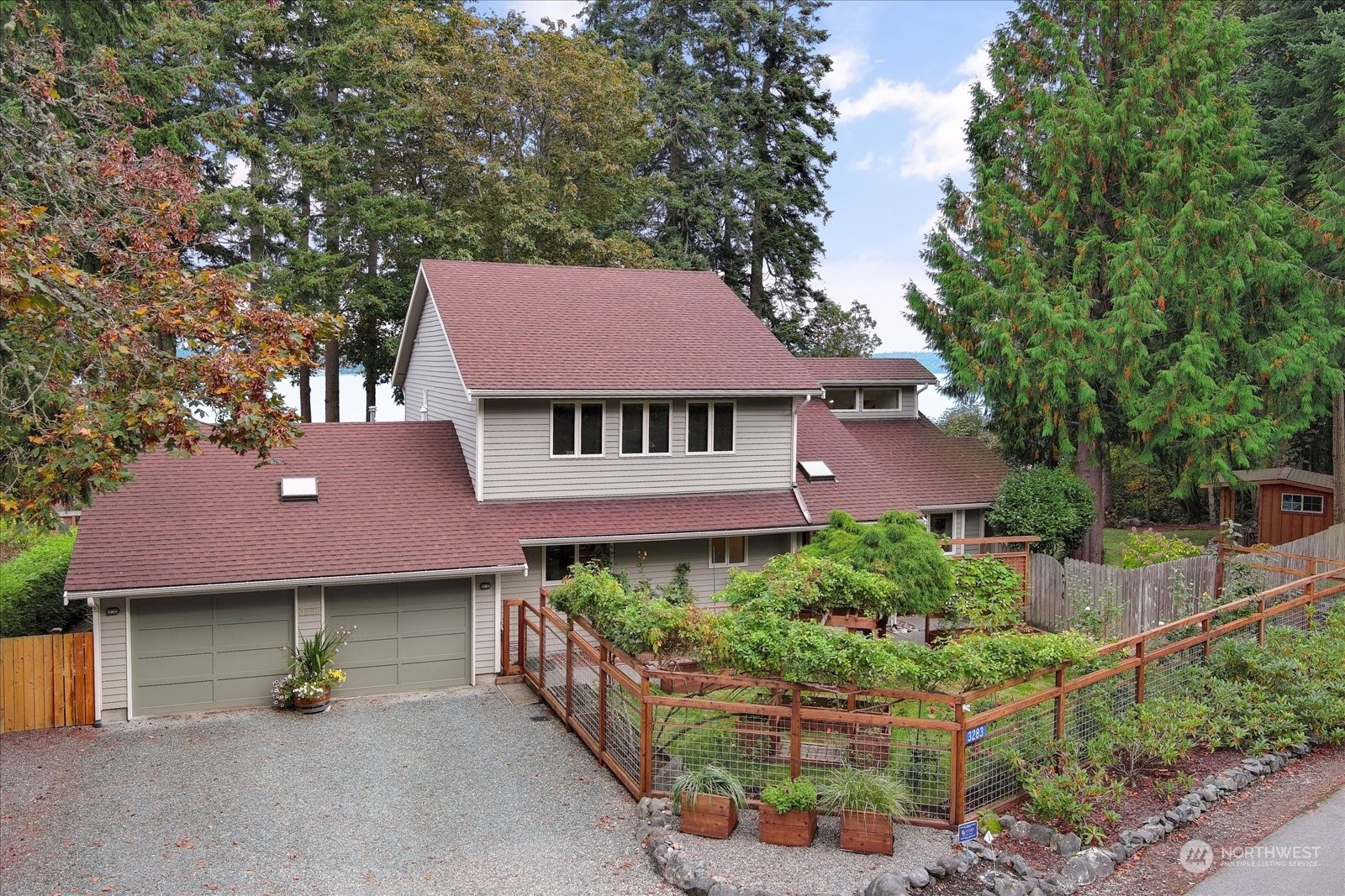 a front view of a house with a garden