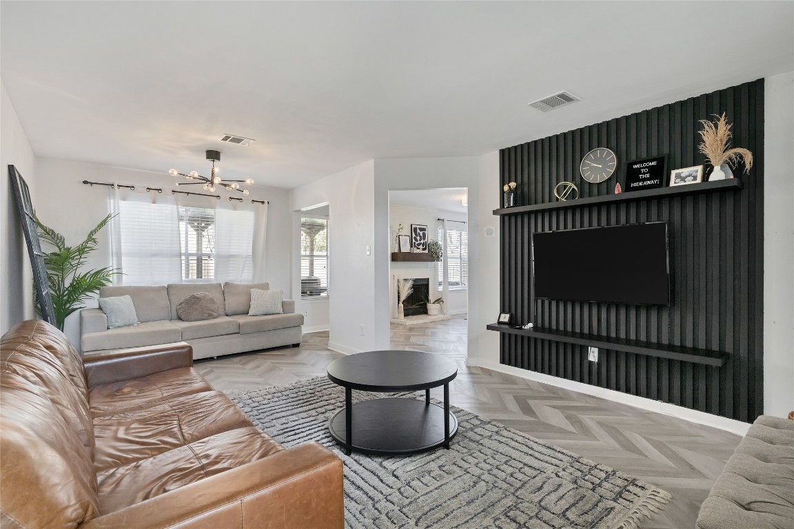 a living room with furniture and a wooden floor