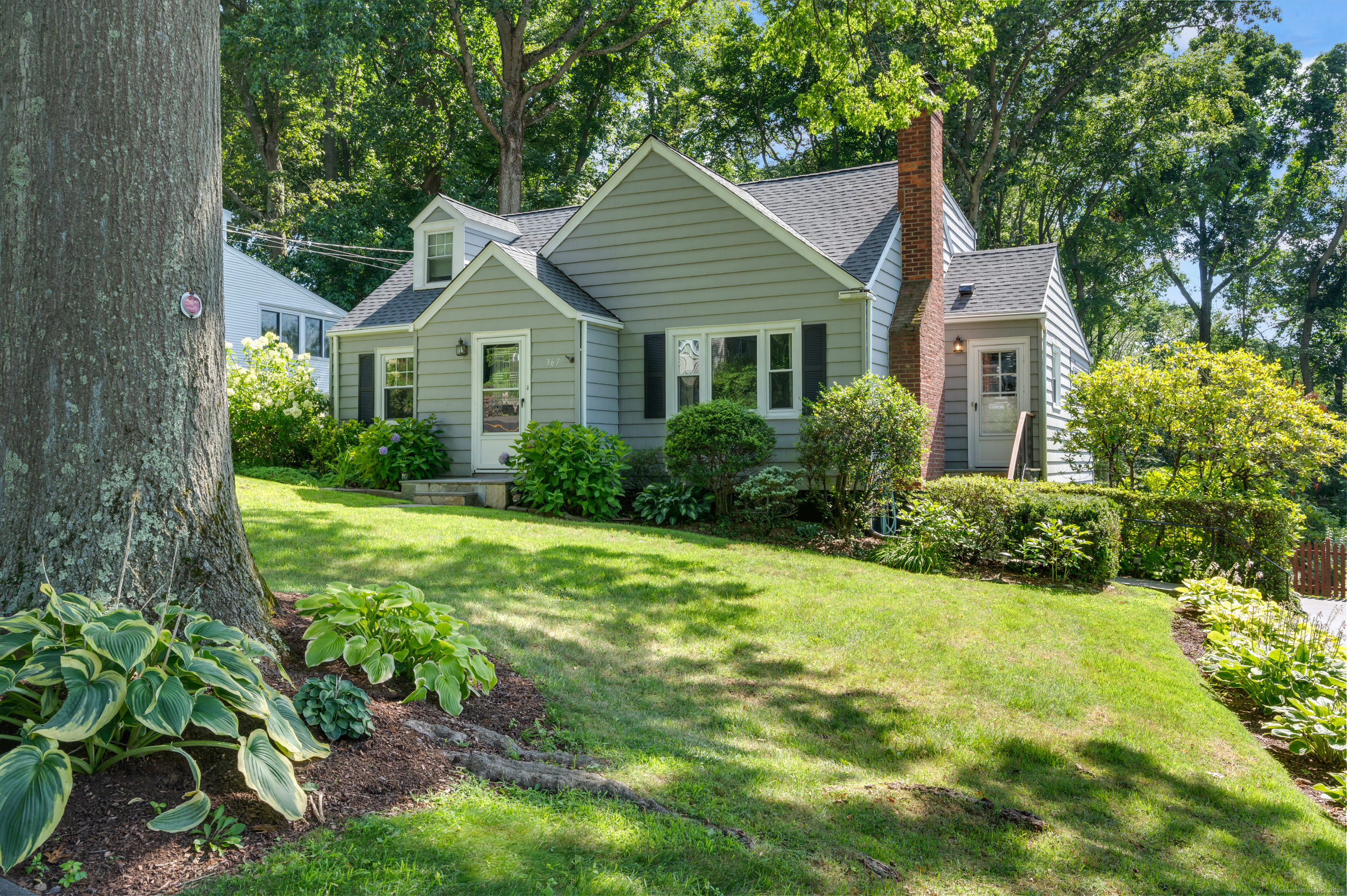 a front view of a house with garden