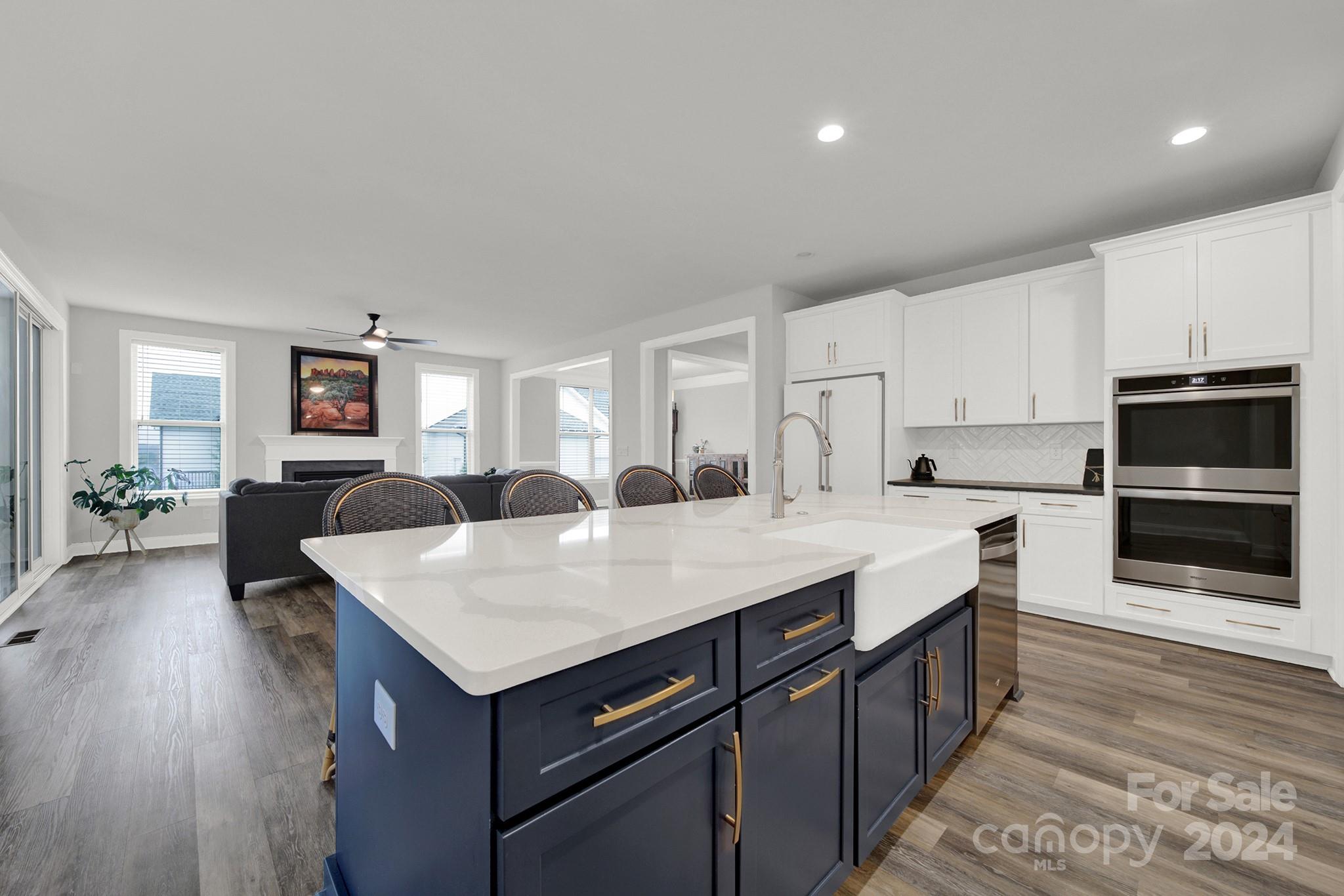 a kitchen with a stove a sink a microwave and cabinets