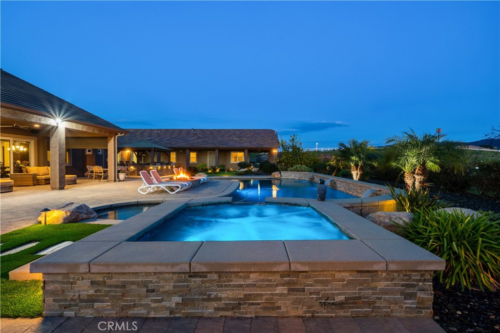 a view of a swimming pool with an outdoor space and seating area