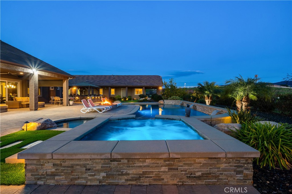 a view of a swimming pool with an outdoor space and seating area