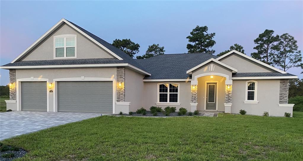 a front view of a house with a yard and garage