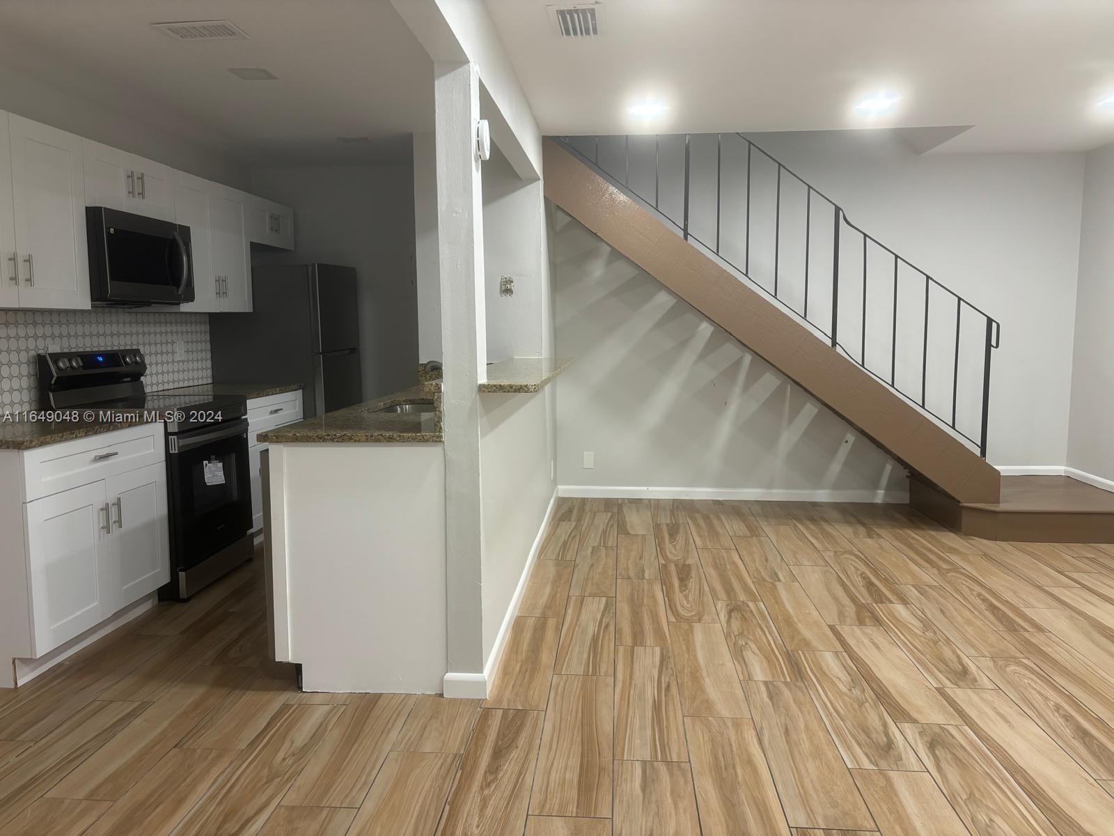 a view of a kitchen from the hallway