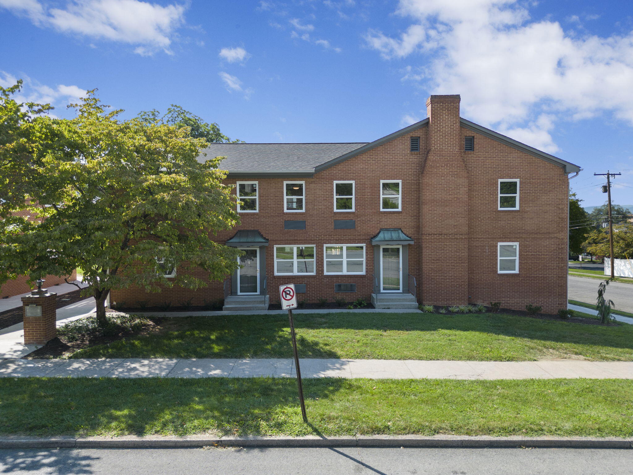 a front view of a house with a garden