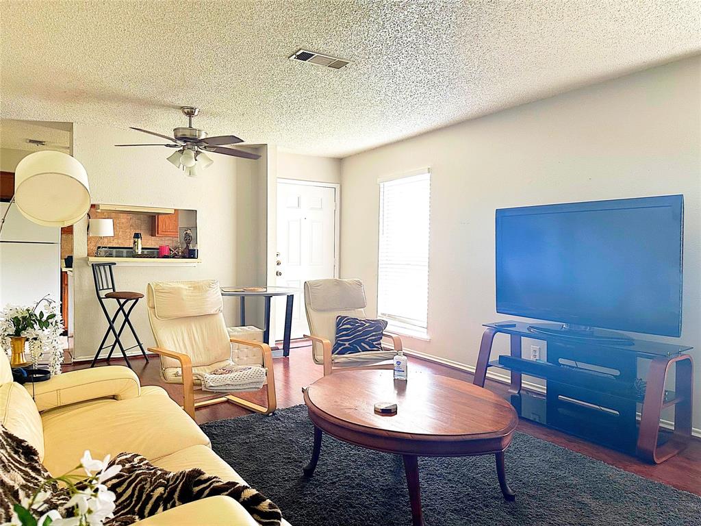 a living room with furniture a chandelier and a table