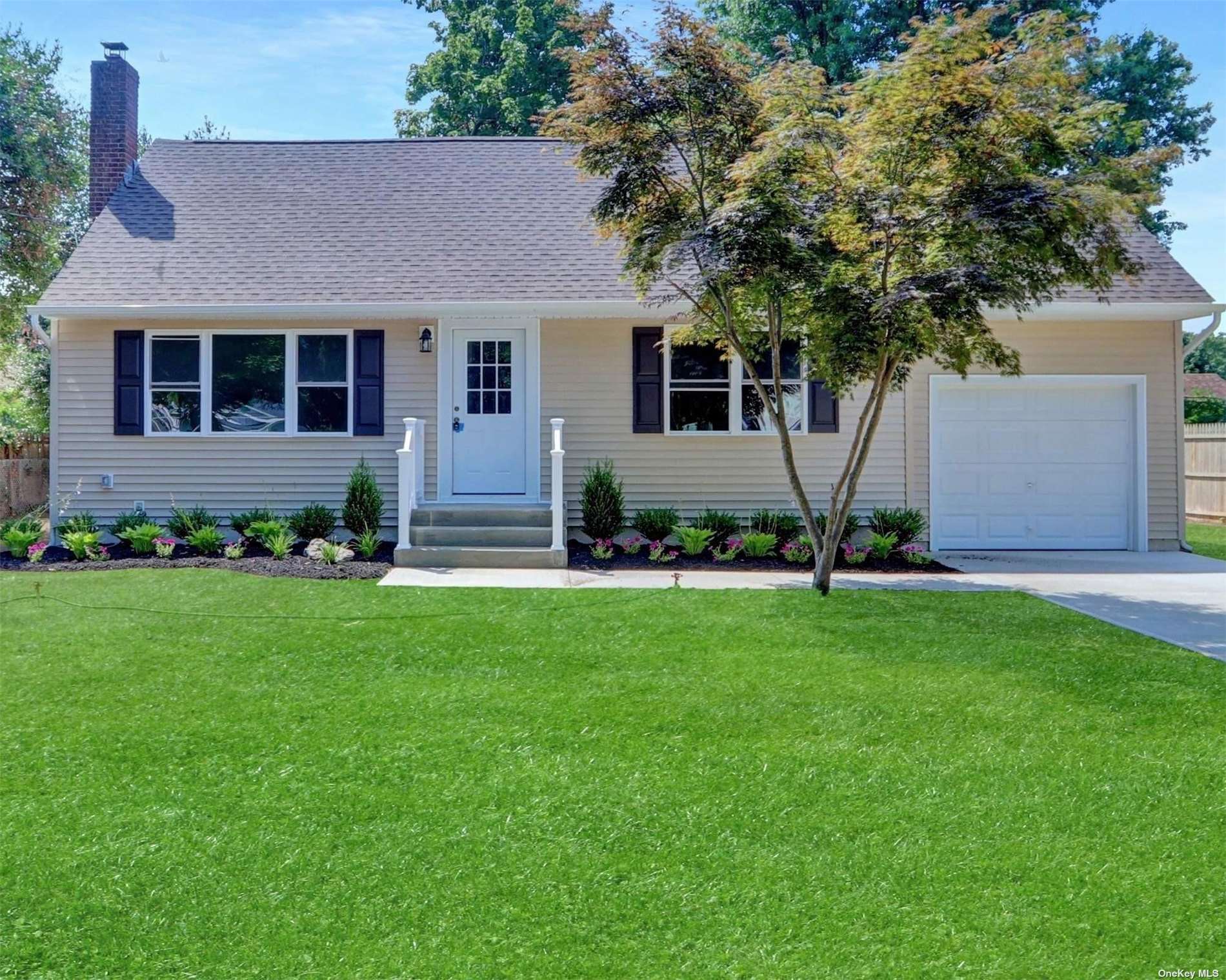 a front view of a house with a yard and yard