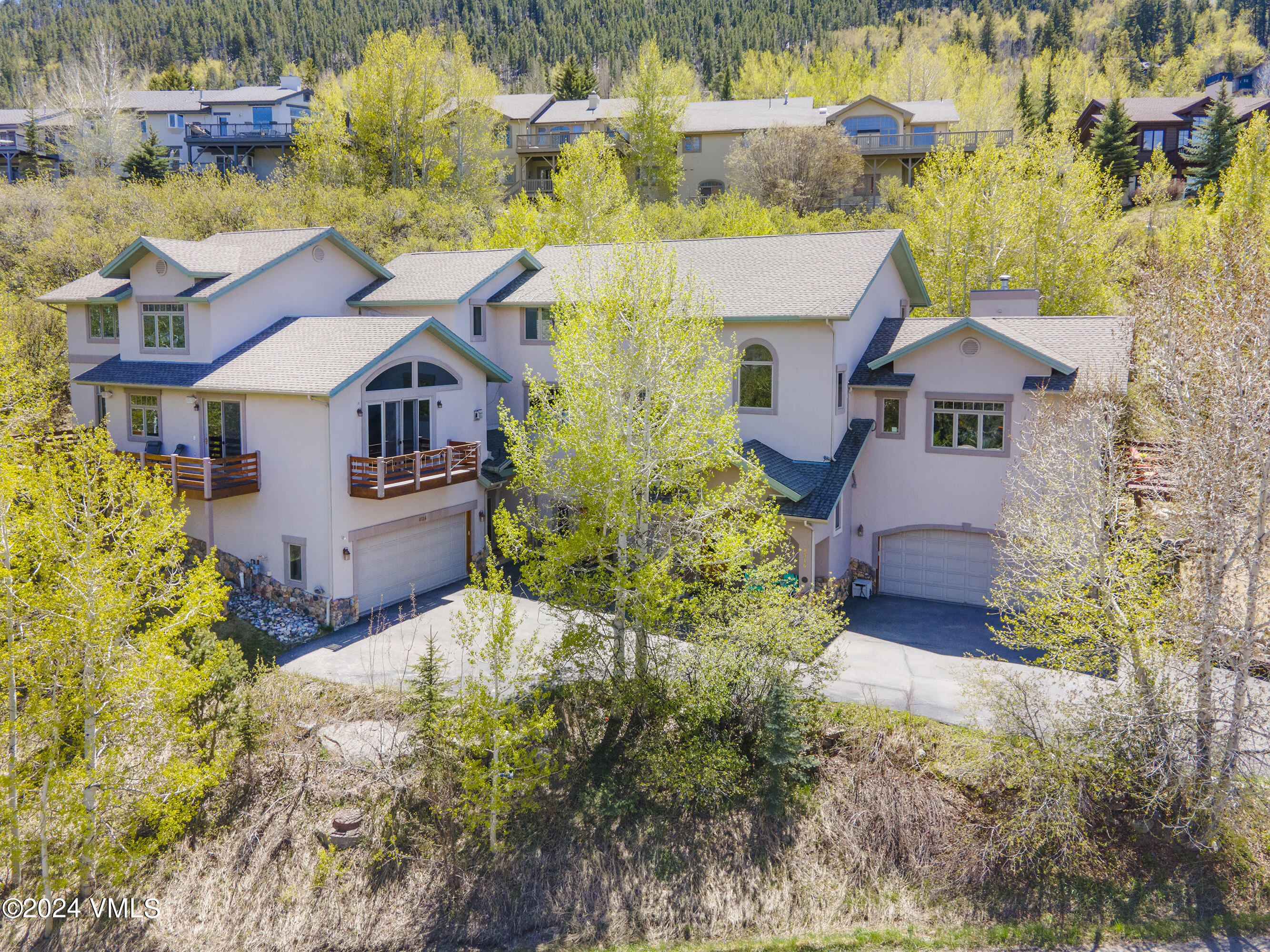 a aerial view of a house with a yard and large trees