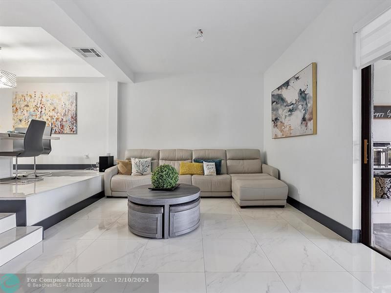 a living room with furniture and white walls