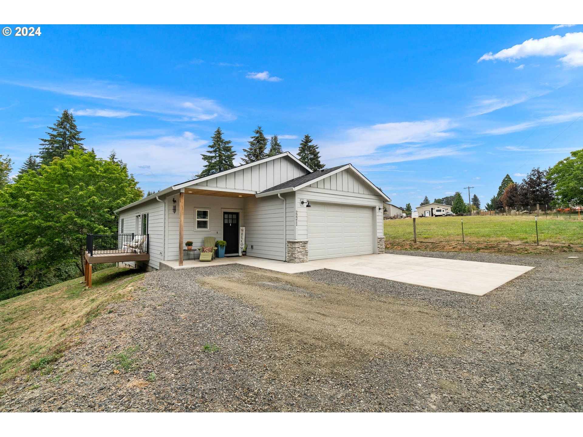 a view of a house with a yard and garage