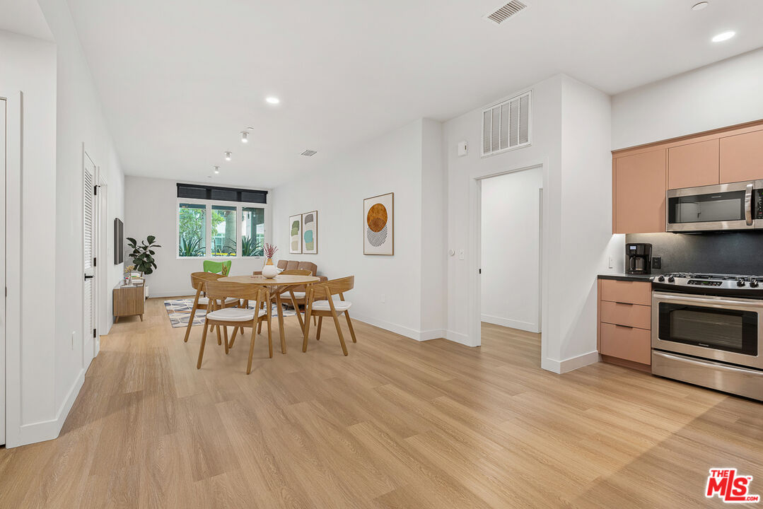 a dining room with furniture and wooden floor