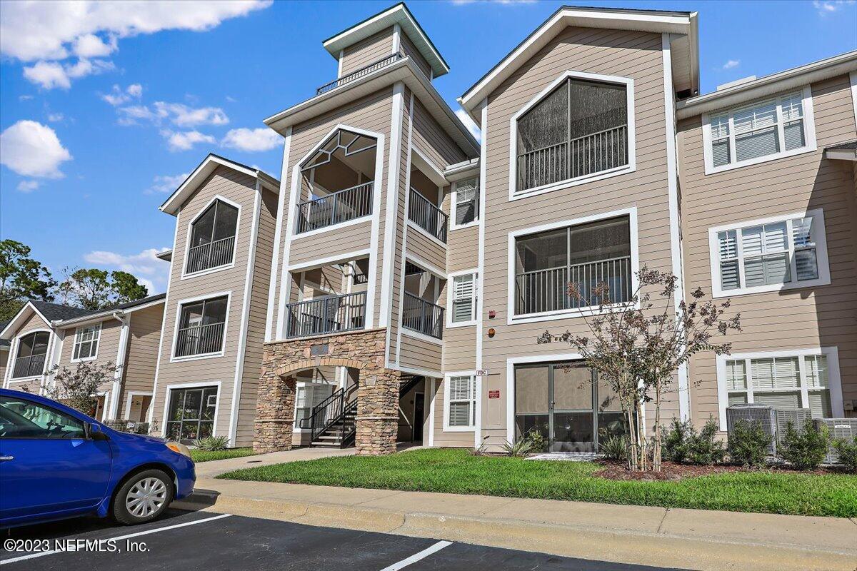 a front view of a residential apartment building with a yard