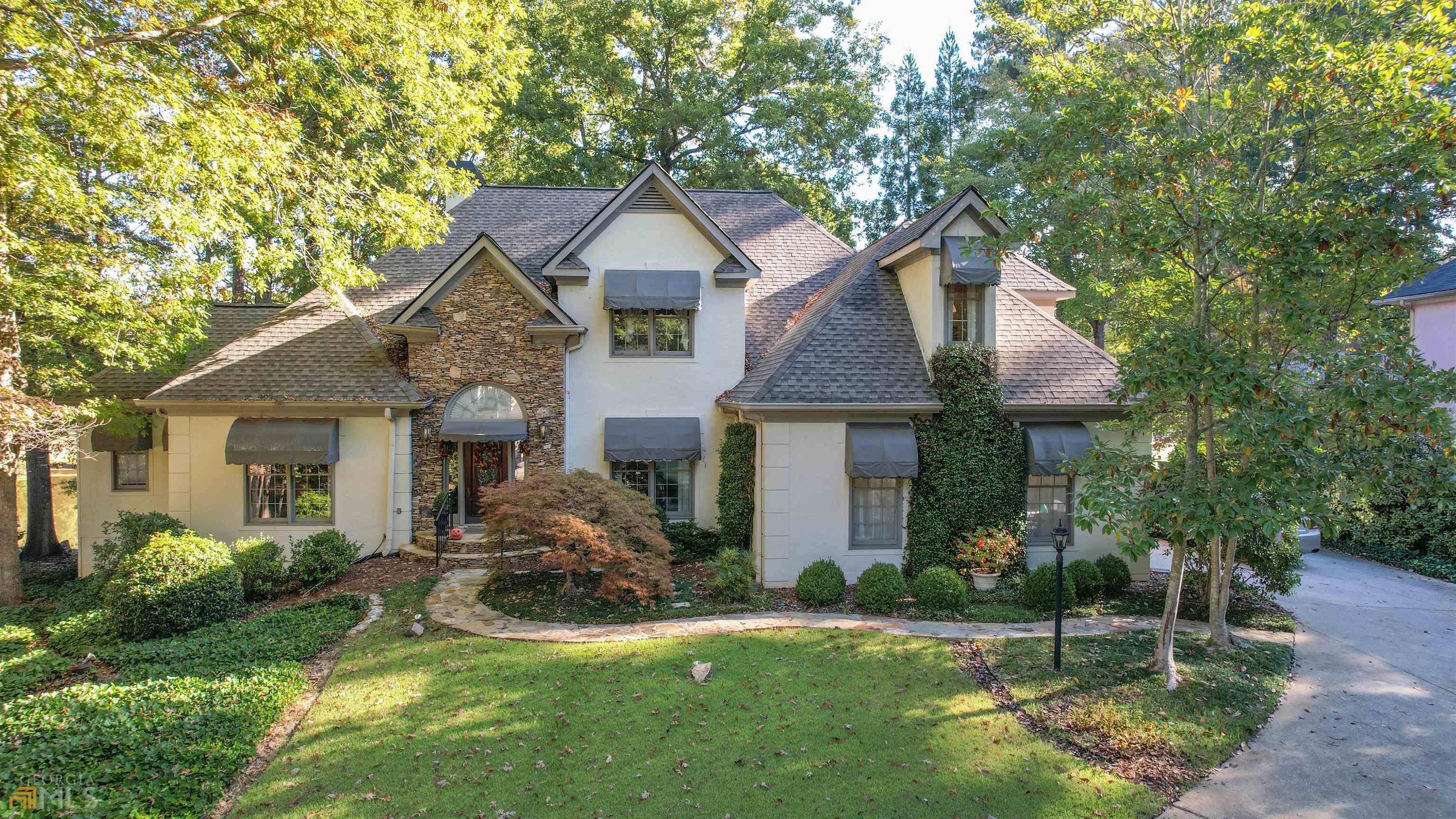 a front view of a house with a yard and porch