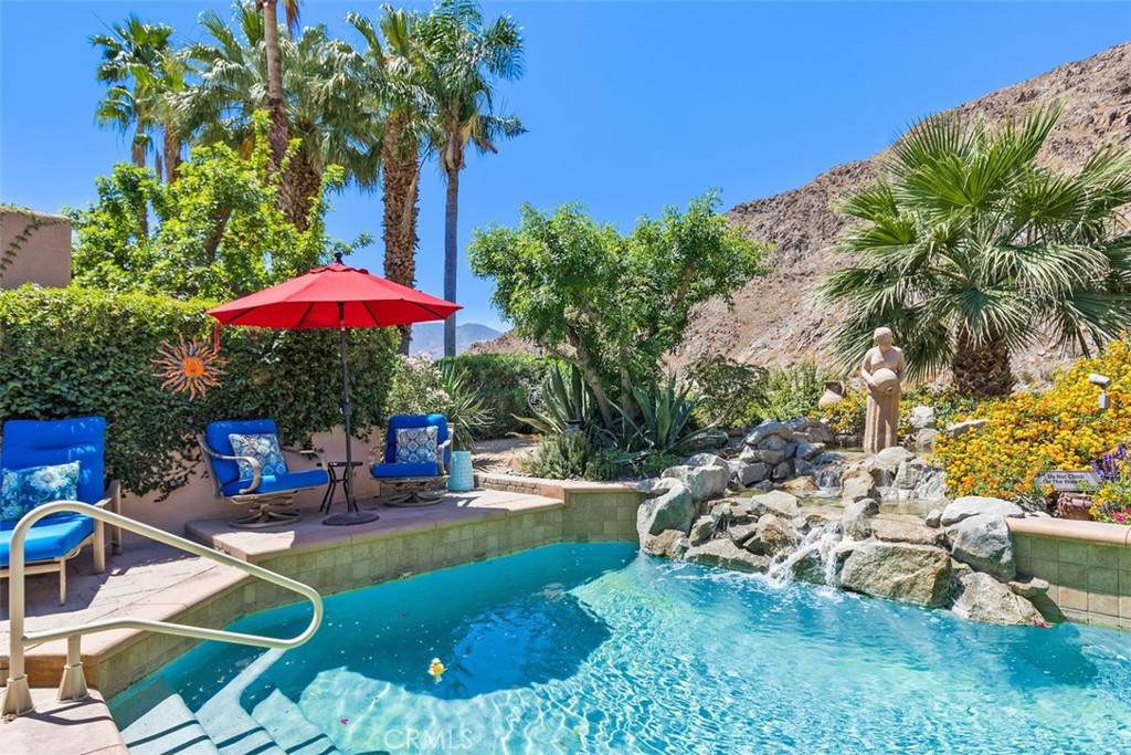 a view of a backyard with plants and patio