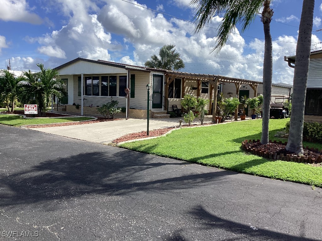 a front view of house with yard and green space