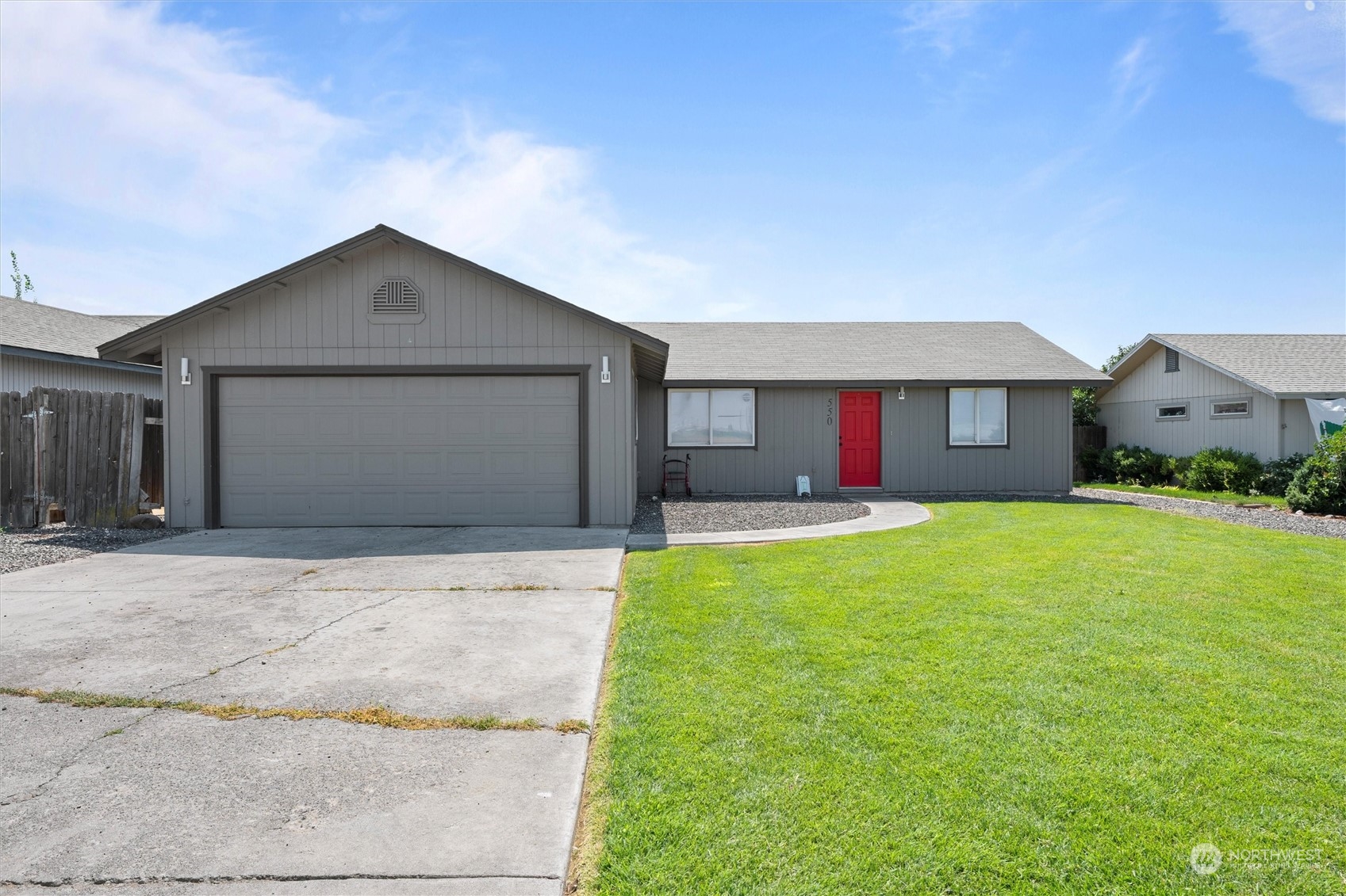 a front view of a house with a yard and garage