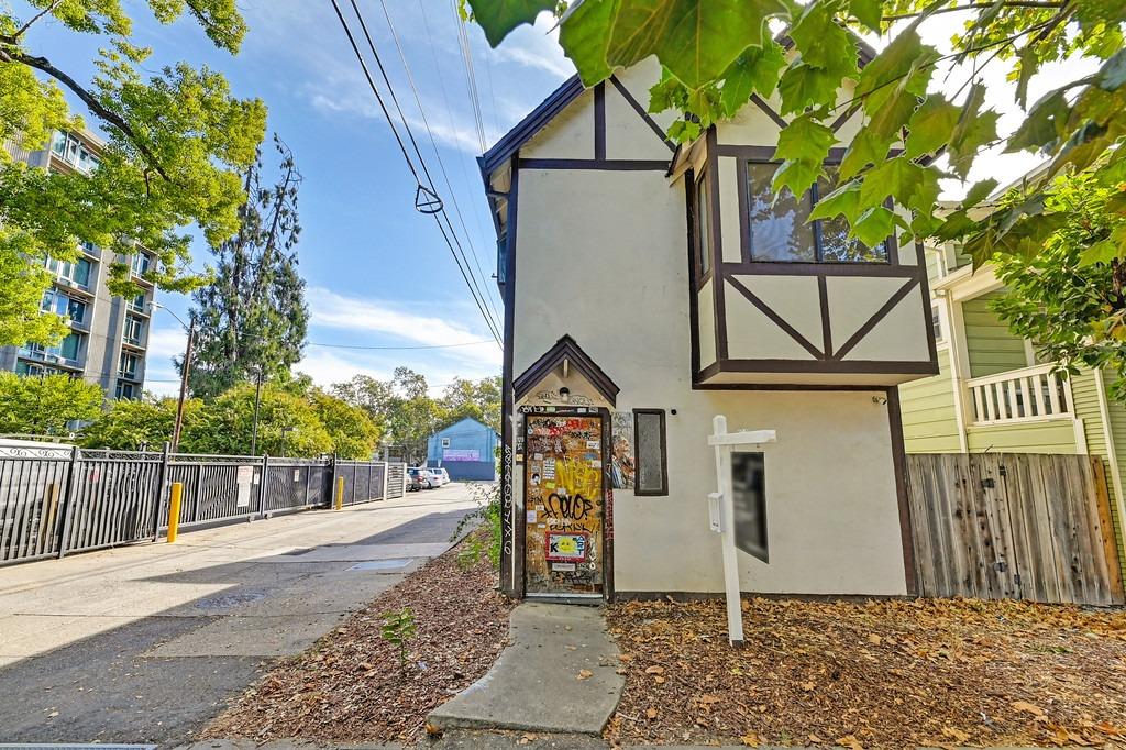 a view of a house with wooden fence next to a road