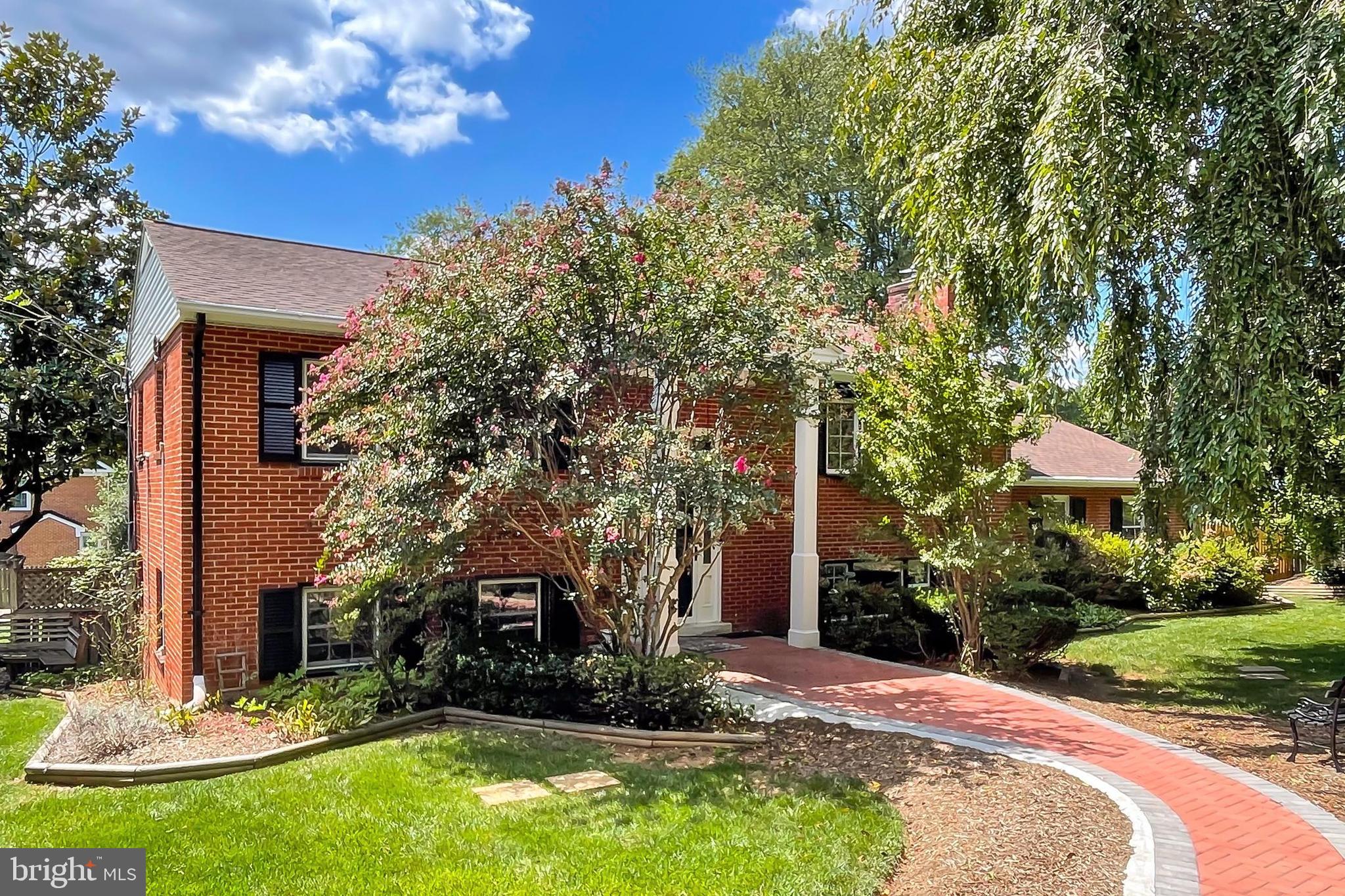 a view of a building with a yard and tree s