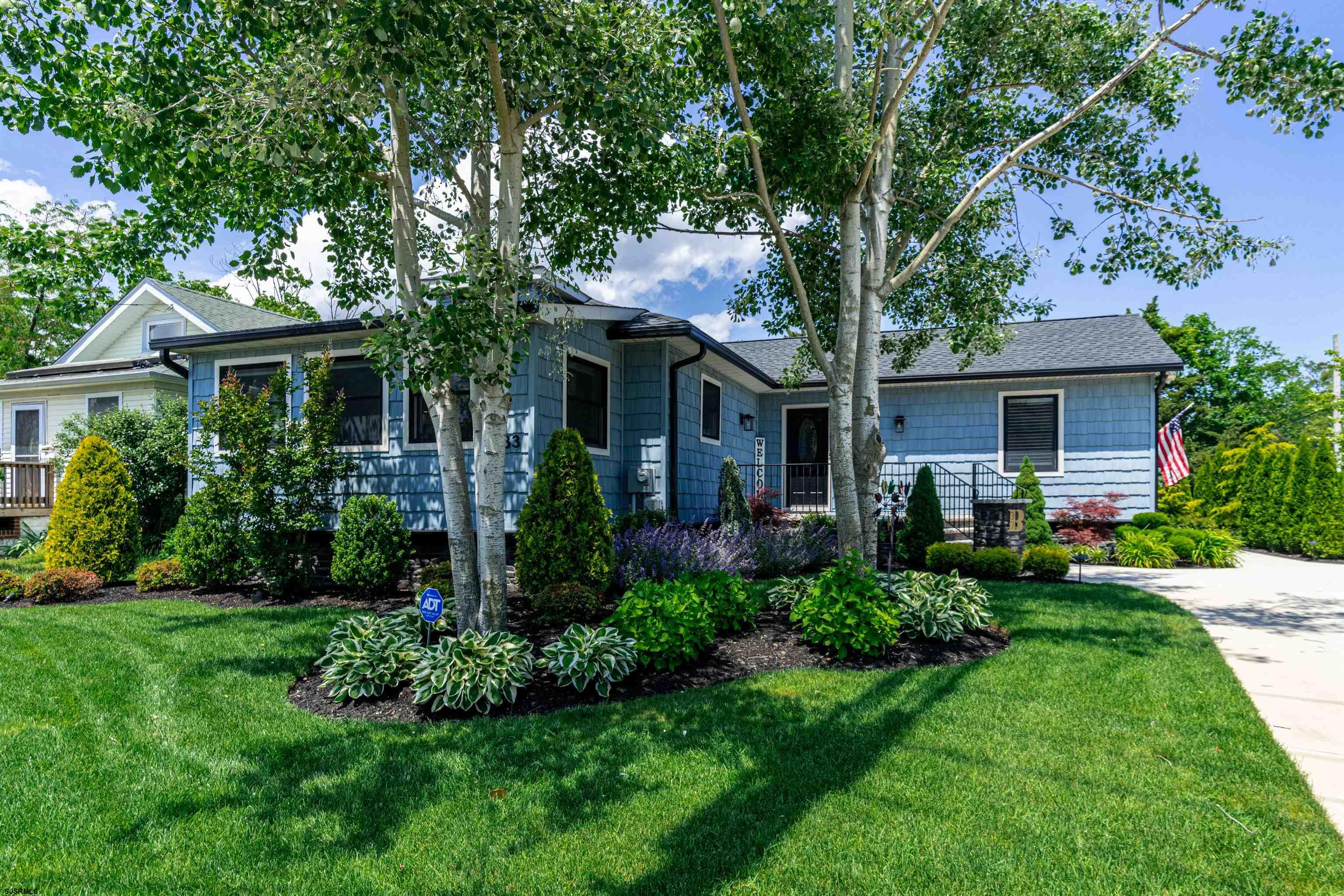 a front view of a house with a yard and porch