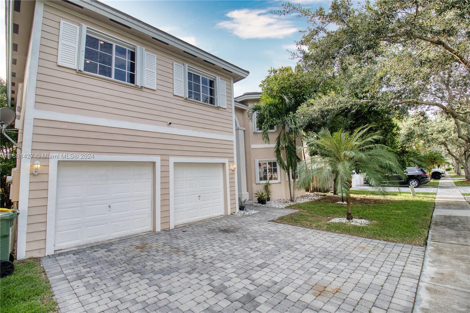 a house that has a tree in front of it