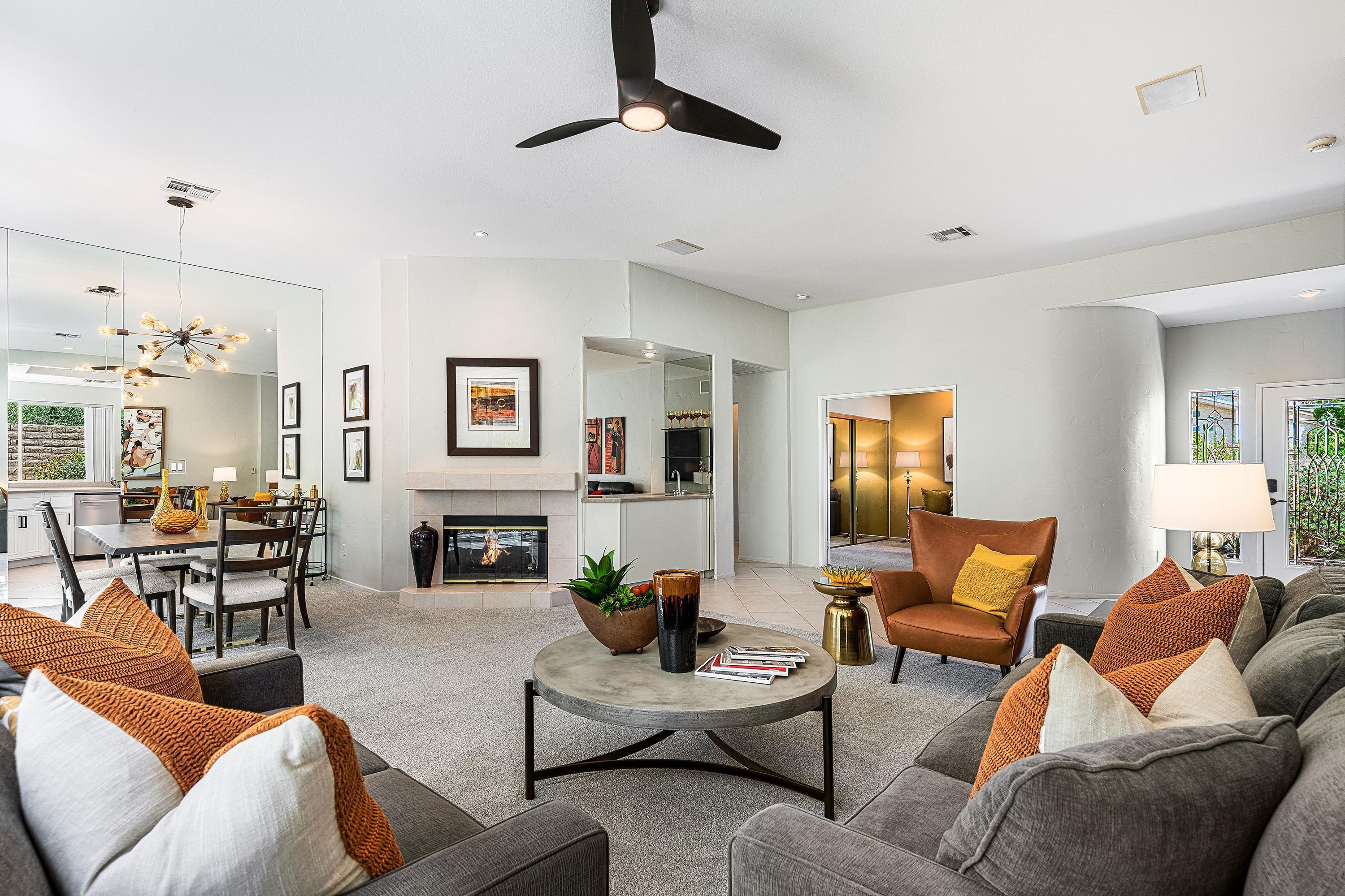 a living room with furniture kitchen view and a window