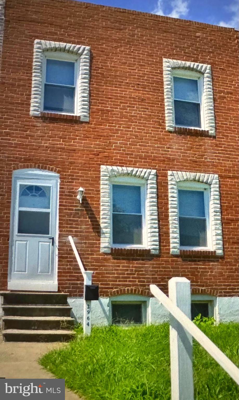 a front view of a house with stairs