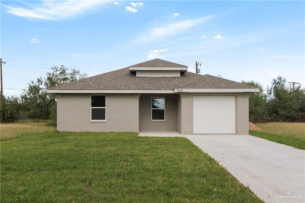 a front view of house with backyard and green space