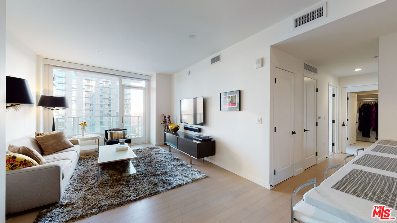 a living room with furniture windows and a table