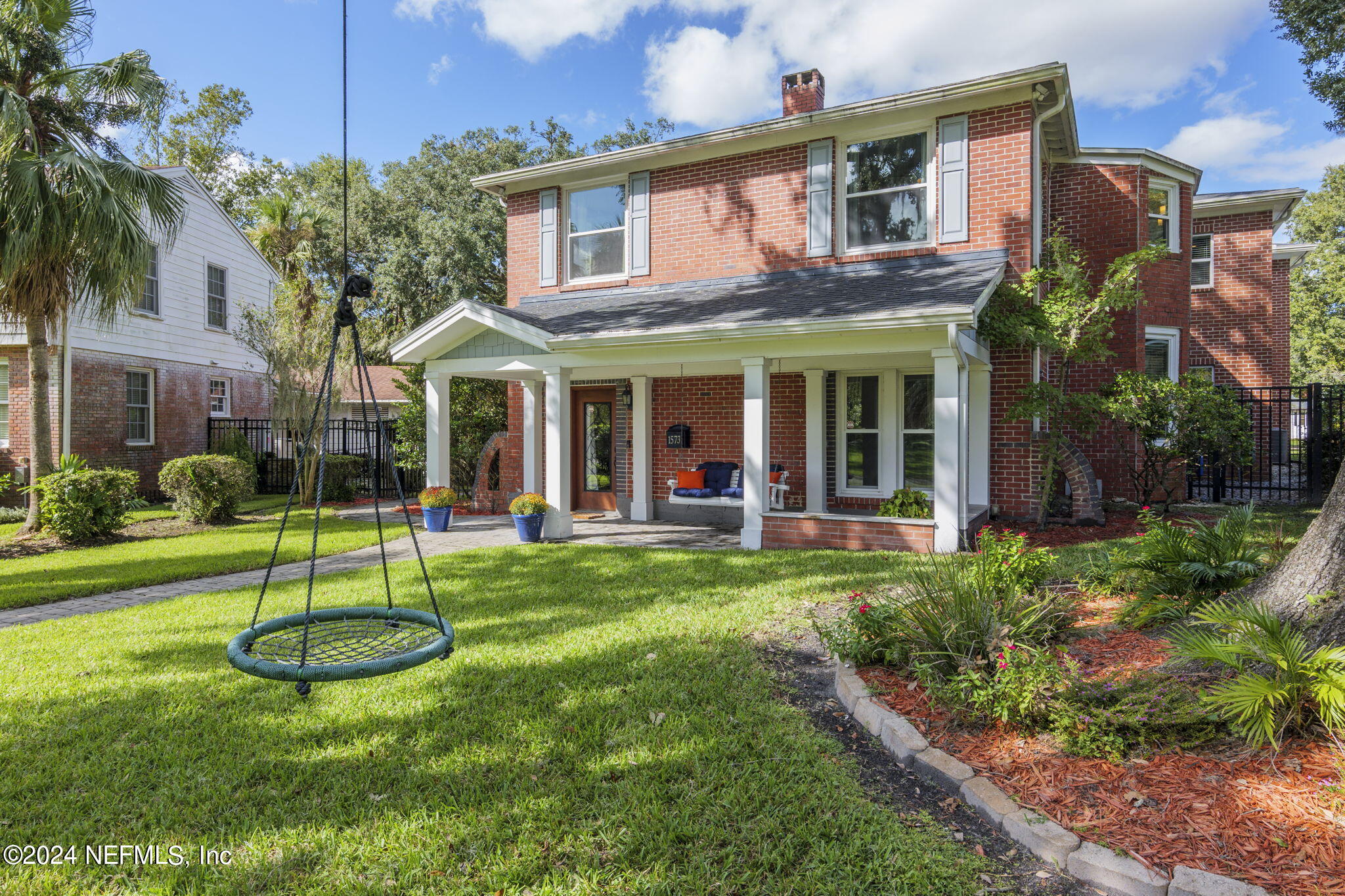 a view of a house with a swimming pool and a yard