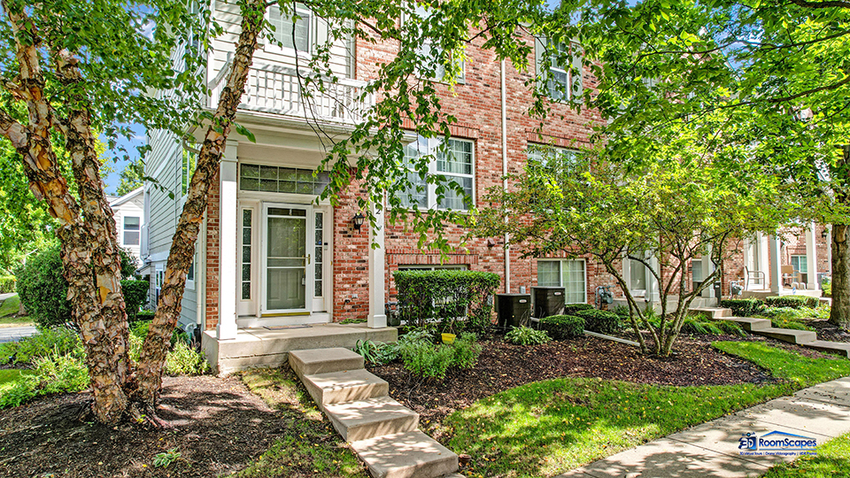 a front view of a house with garden