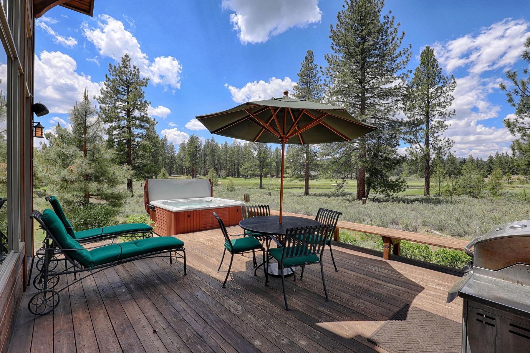 a view of backyard with seating space and trees