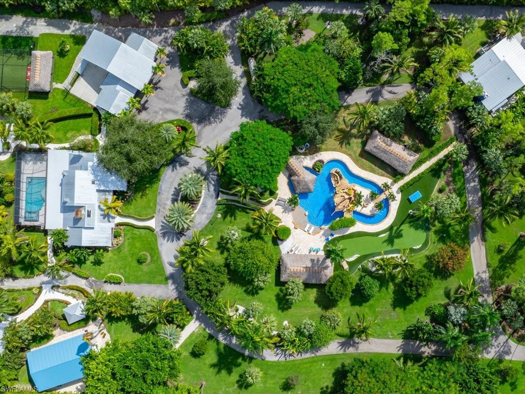 an aerial view of a house with a yard and garden