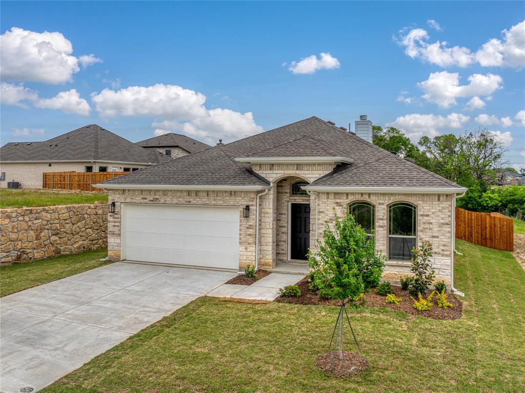 a front view of a house with a yard garage and outdoor seating