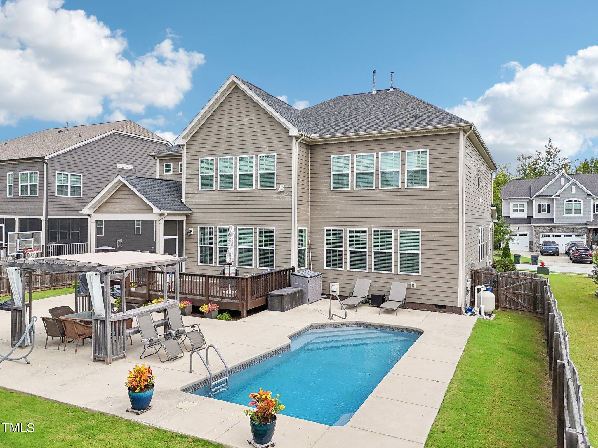 a front view of a house with swimming pool having outdoor seating