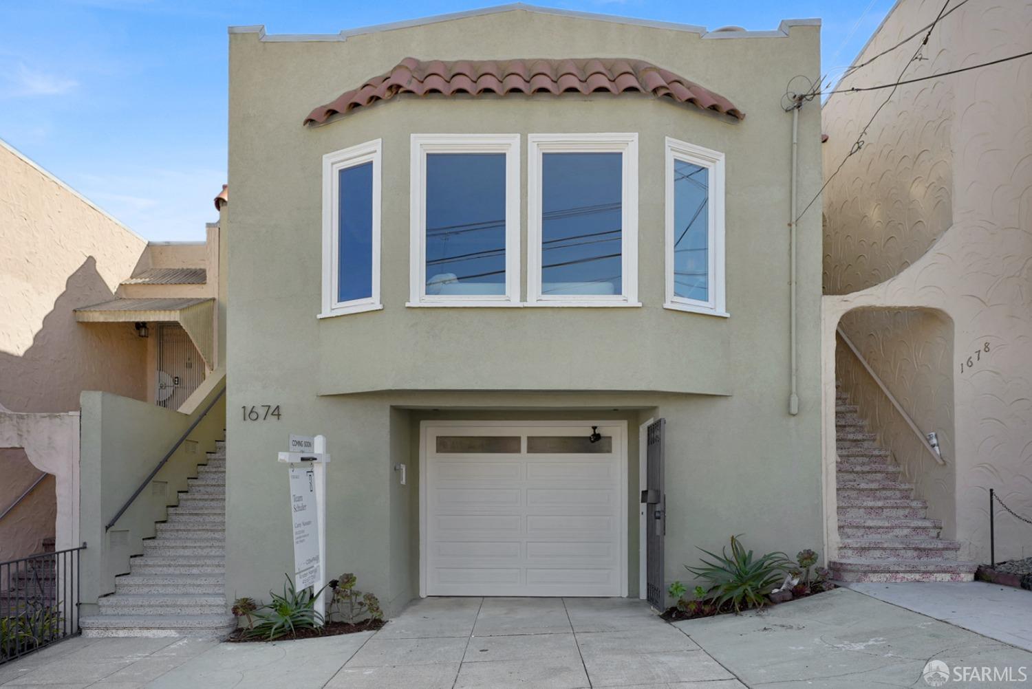 a front view of a house with a garage