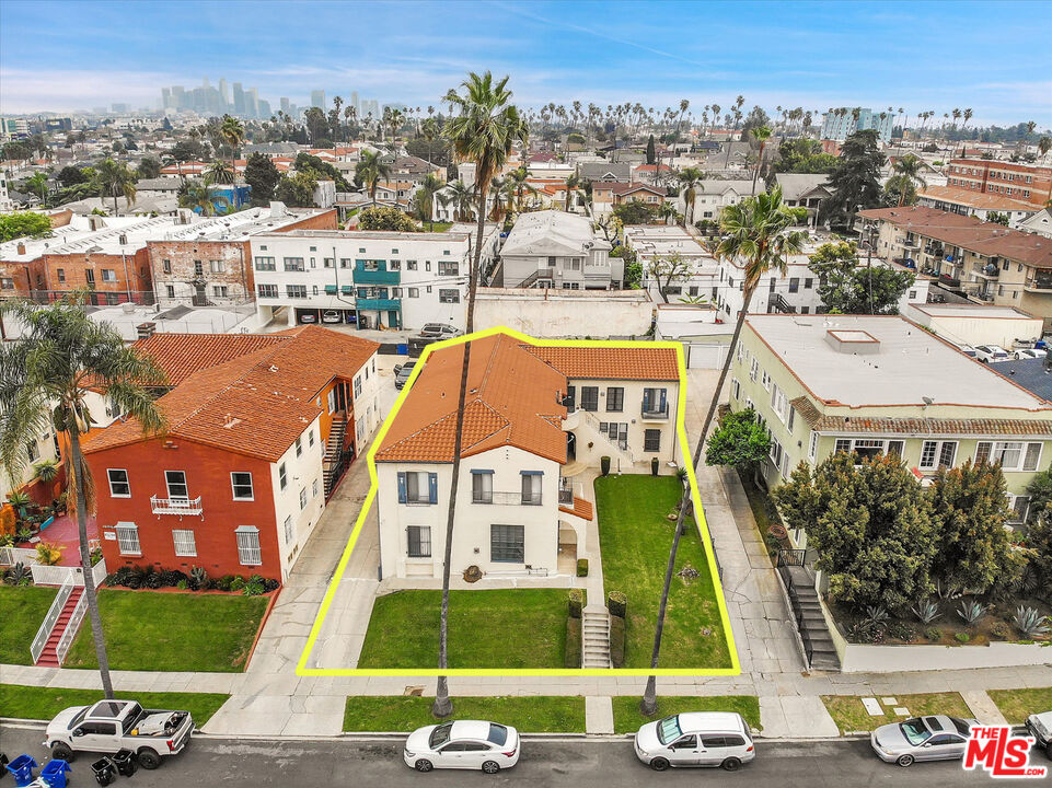 an aerial view of residential houses with outdoor space and street view