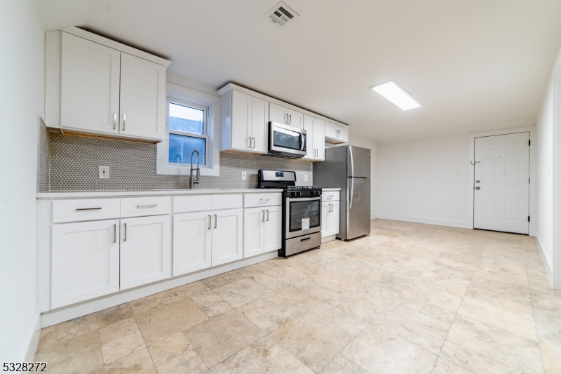 a kitchen with stainless steel appliances a sink and cabinets