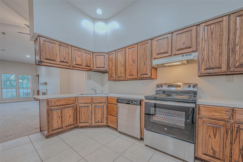 a kitchen with granite countertop cabinets stainless steel appliances and a sink