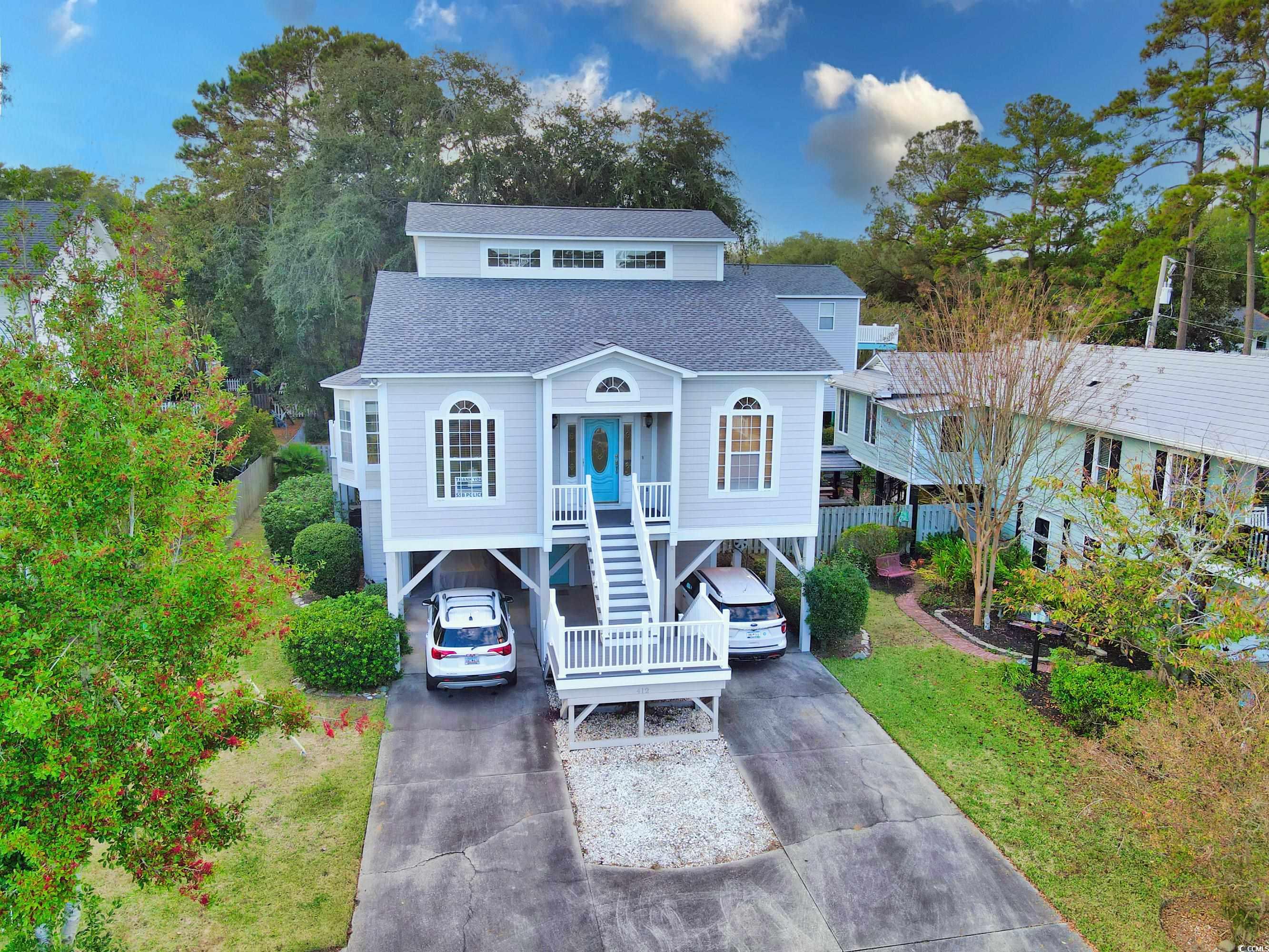 Beach home featuring covered porch and a carport