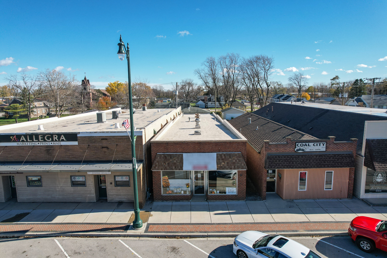 a front view of a building with parking area