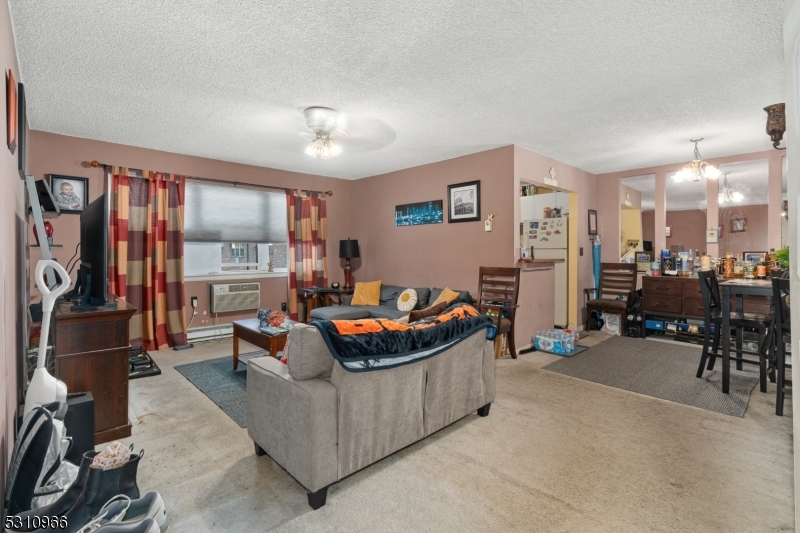 a living room with furniture a flat screen tv and a table