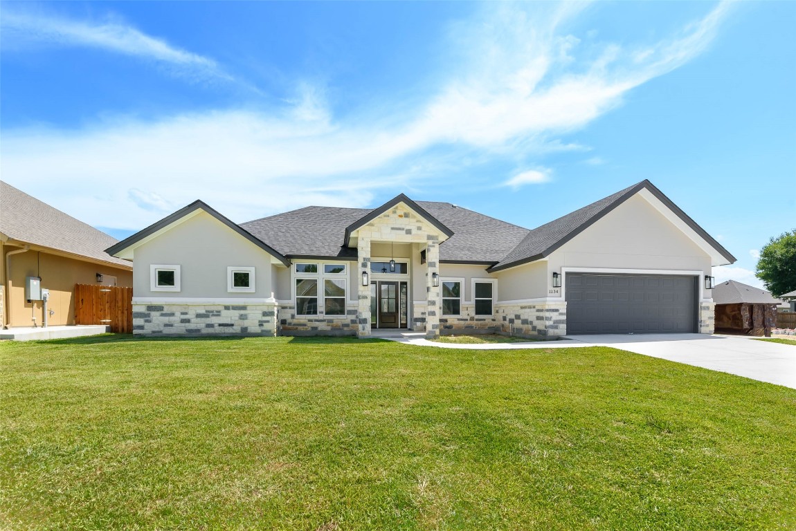 a view of a house with a big yard and large trees