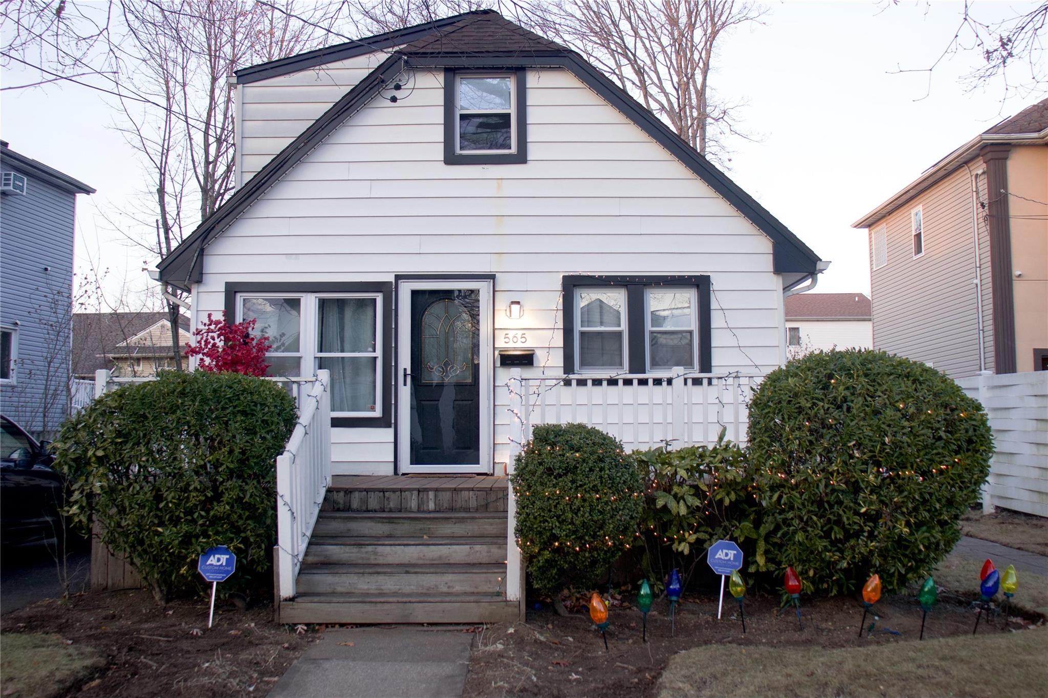 a front view of a house with plants