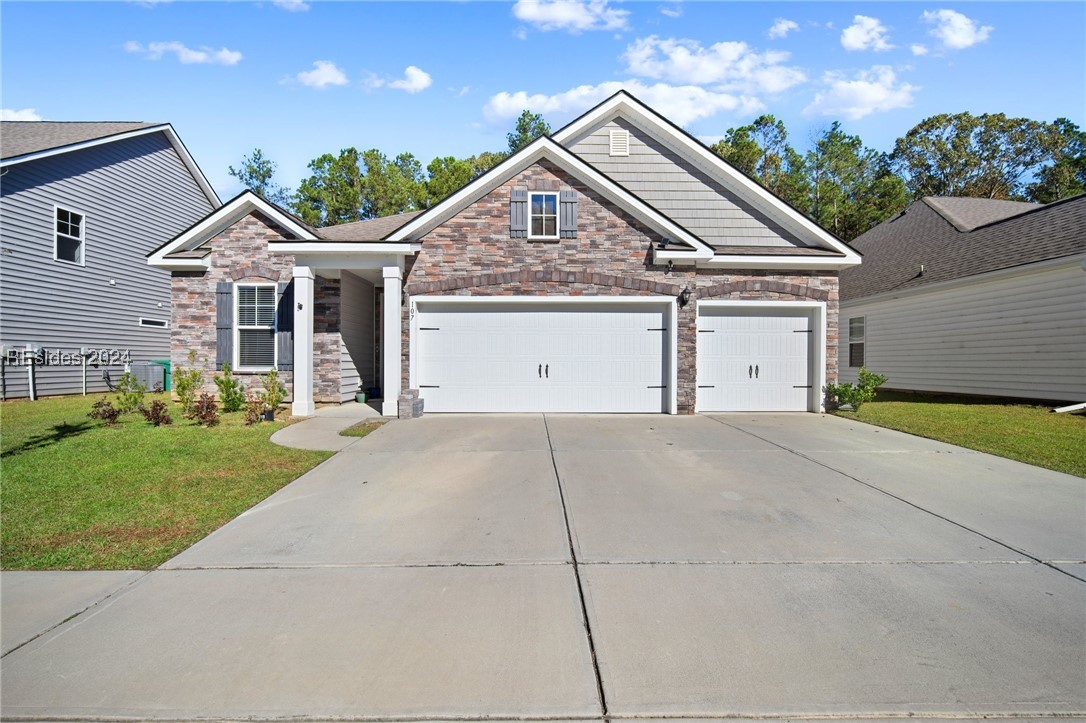 Craftsman-style home with a garage and a front yar