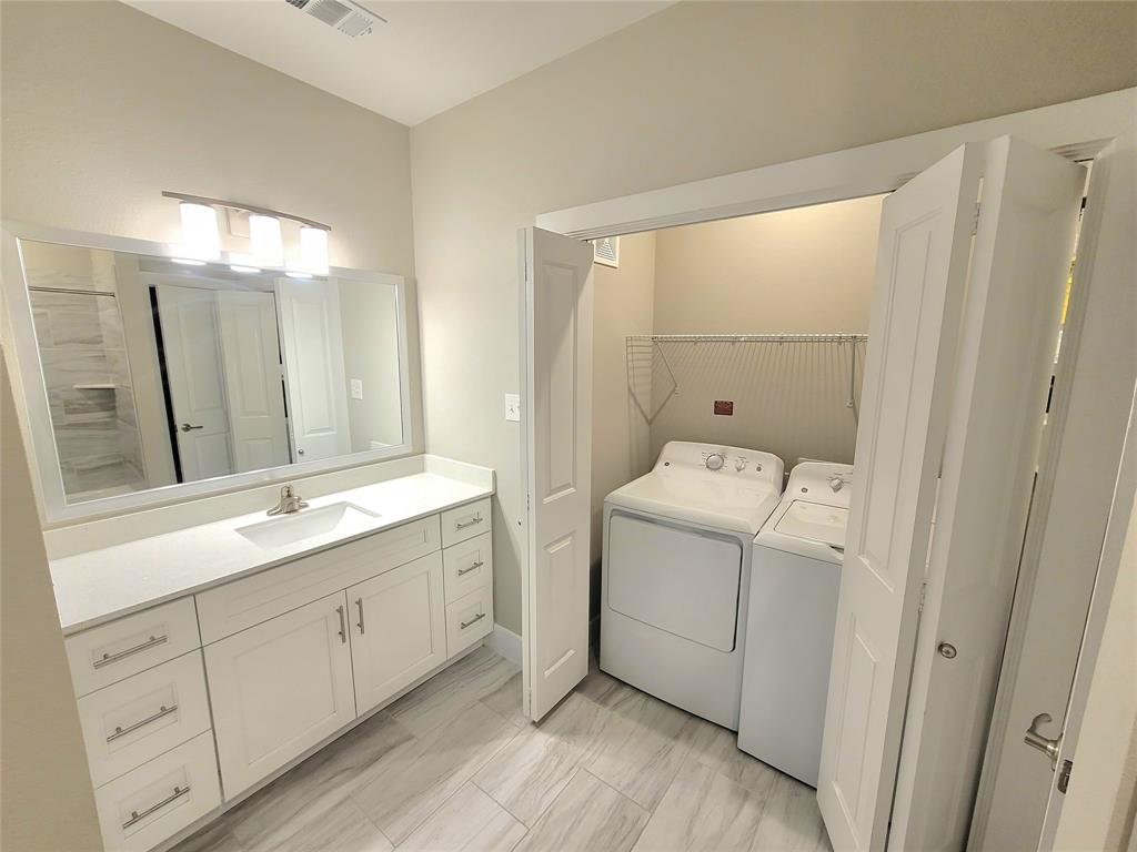 a bathroom with a granite countertop sink a toilet and a mirror