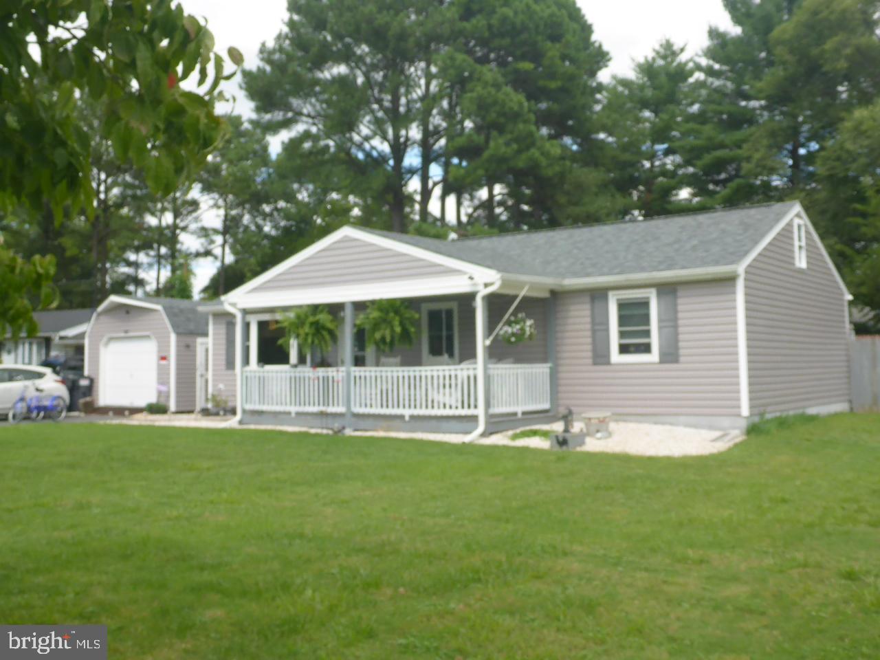 a front view of a house with a garden and yard