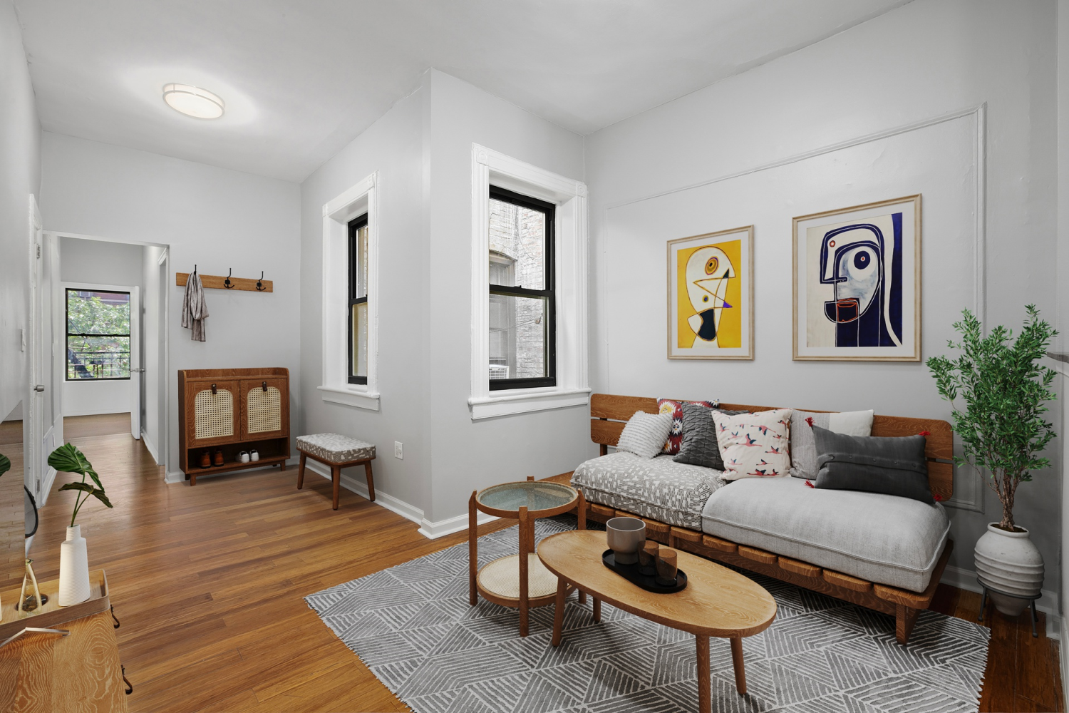 a living room with furniture and a wooden floor