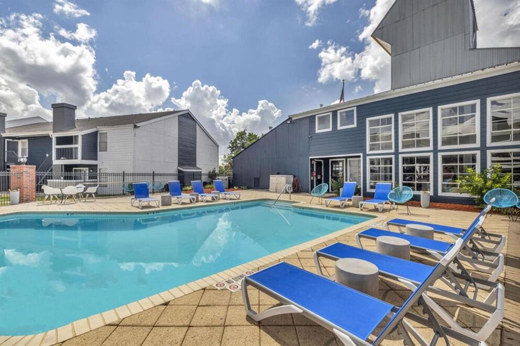 a front view of a house with swimming pool having outdoor seating