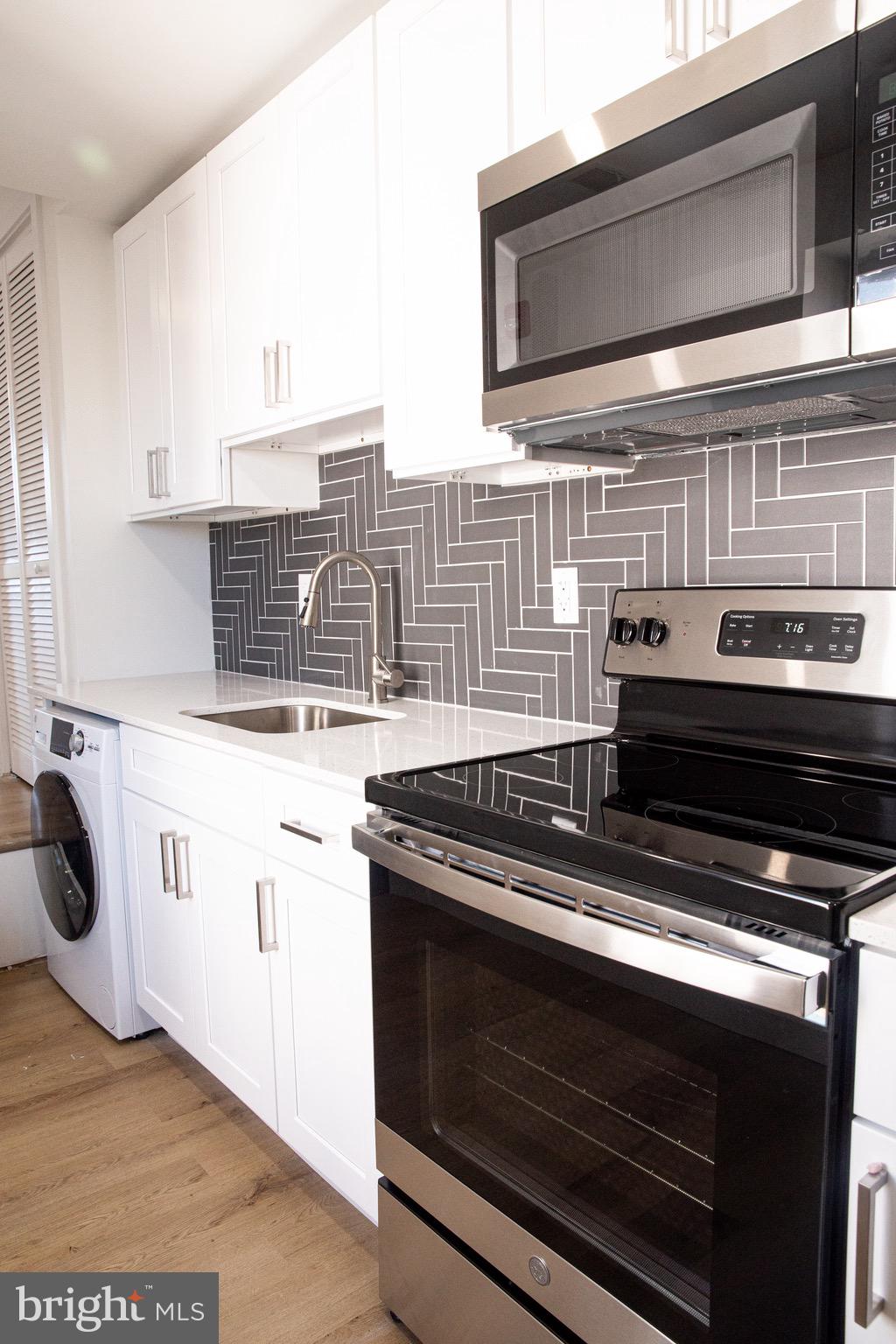 a stove top oven sitting inside of a kitchen